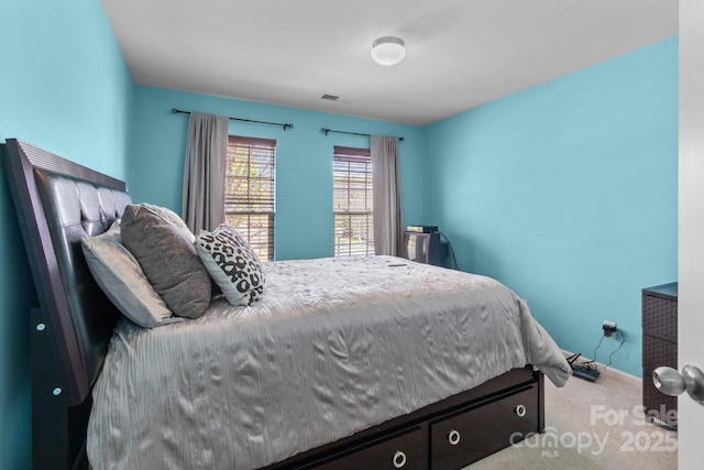 bedroom featuring carpet floors and visible vents
