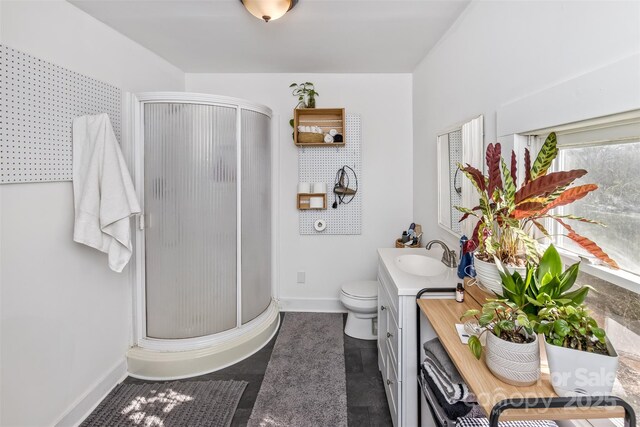 21 Hilldale Rd, Asheville, NC 28803 - bathroom with toilet, vanity, a stall shower, and baseboards
