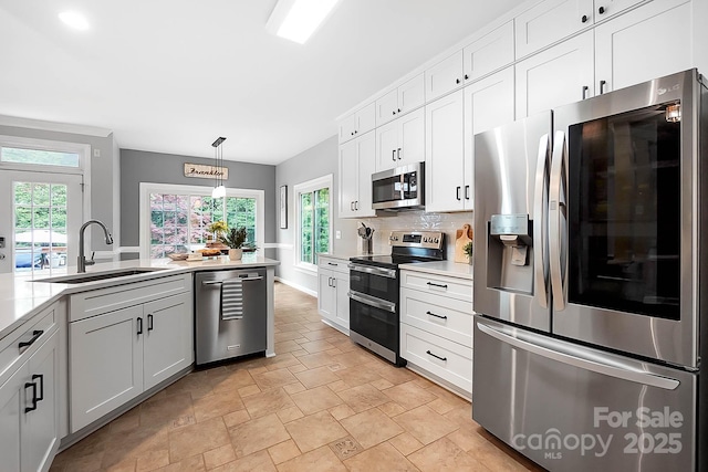 1214 Foxfield Rd, Waxhaw, NC 28173 - kitchen featuring appliances with stainless steel finishes, a sink, stone finish flooring, and healthy amount of natural light