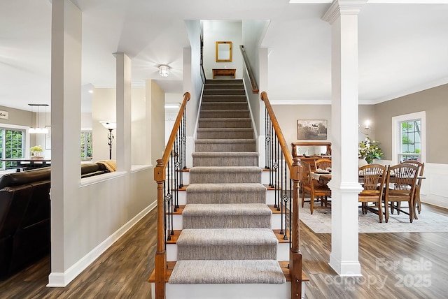 1214 Foxfield Rd, Waxhaw, NC 28173 - stairway featuring decorative columns, wood finished floors, plenty of natural light, and ornamental molding