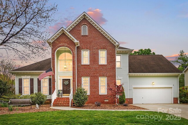 1214 Foxfield Rd, Waxhaw, NC 28173 - view of front of house with an attached garage, concrete driveway, a yard, and brick siding