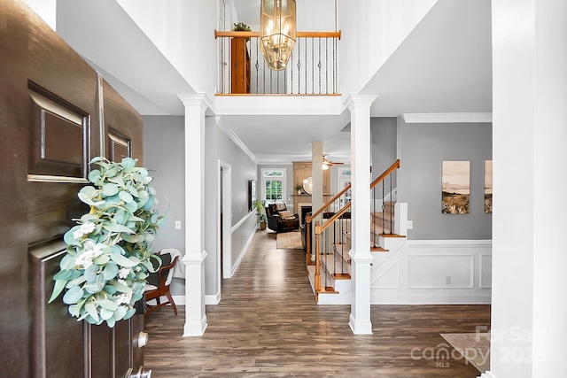 1214 Foxfield Rd, Waxhaw, NC 28173 - foyer featuring ornate columns, wood finished floors, ornamental molding, stairway, and baseboards