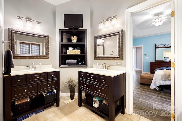 1214 Foxfield Rd, Waxhaw, NC 28173 - full bathroom with two vanities, baseboards, ceiling fan, connected bathroom, and built in shelves