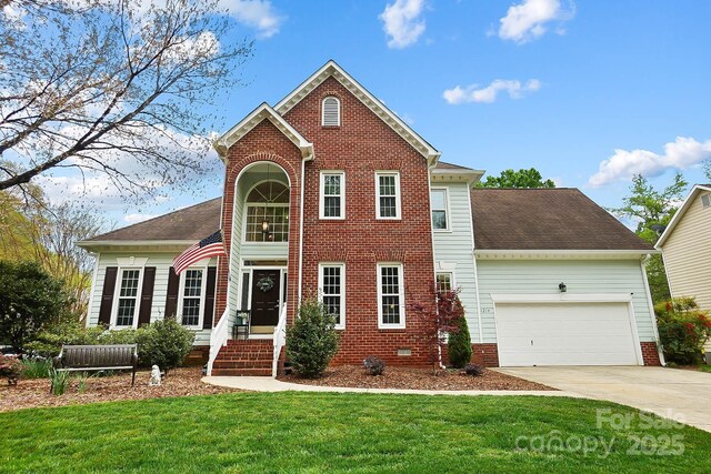 1214 Foxfield Rd, Waxhaw, NC 28173 - view of front of house with an attached garage, driveway, a front lawn, and brick siding