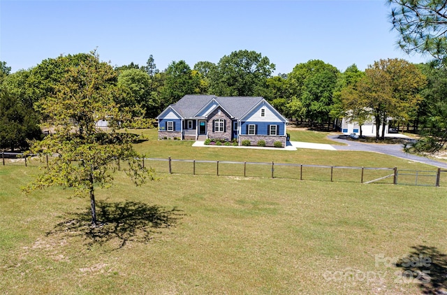 view of front of home with a front lawn, fence, and driveway