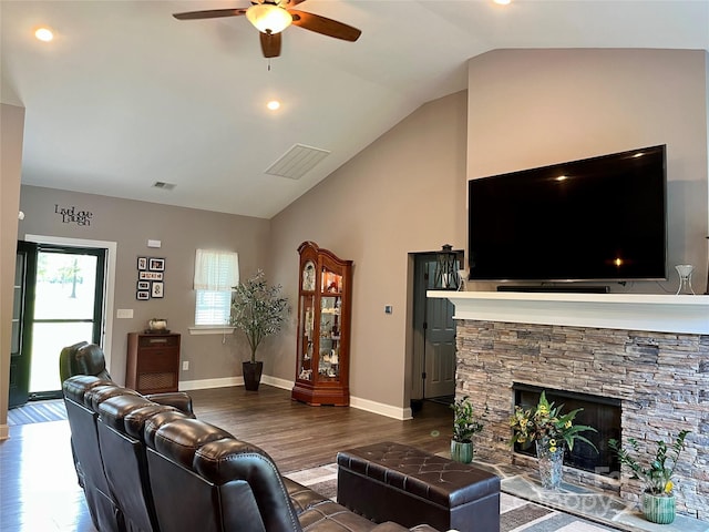 living room featuring ceiling fan, visible vents, dark wood finished floors, baseboards, and vaulted ceiling