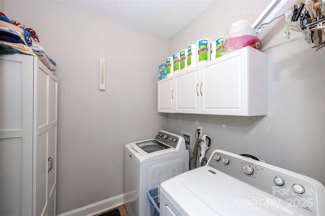 laundry room featuring separate washer and dryer and cabinet space