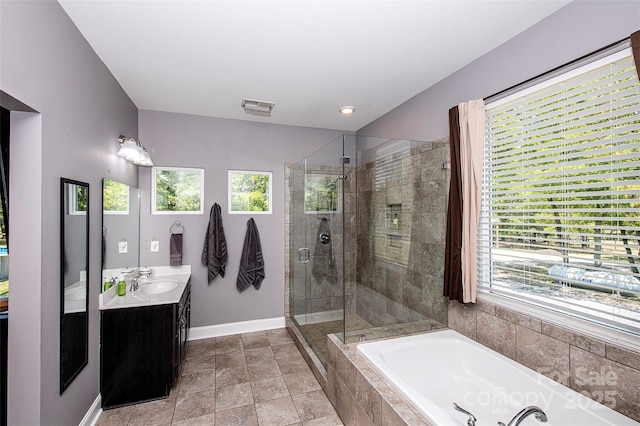 bathroom featuring visible vents, a garden tub, a wealth of natural light, and a shower stall