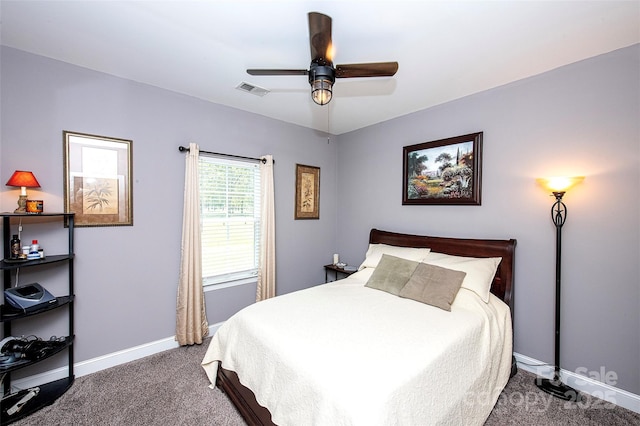 carpeted bedroom featuring baseboards, ceiling fan, and visible vents