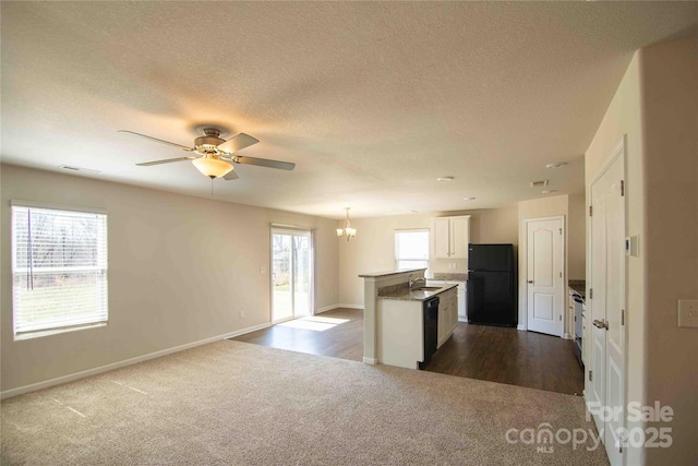 kitchen featuring open floor plan, visible vents, black appliances, and a wealth of natural light