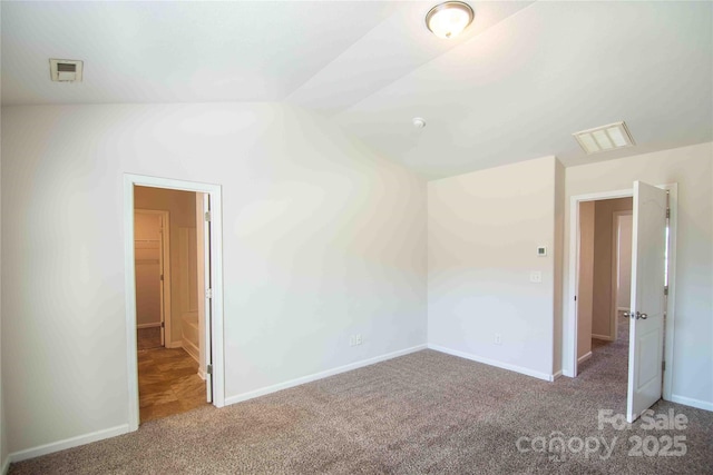 unfurnished bedroom with baseboards, visible vents, and carpet