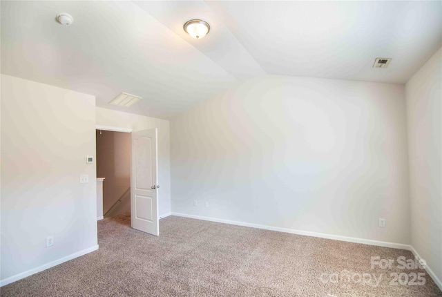 spare room with baseboards, visible vents, and carpet floors