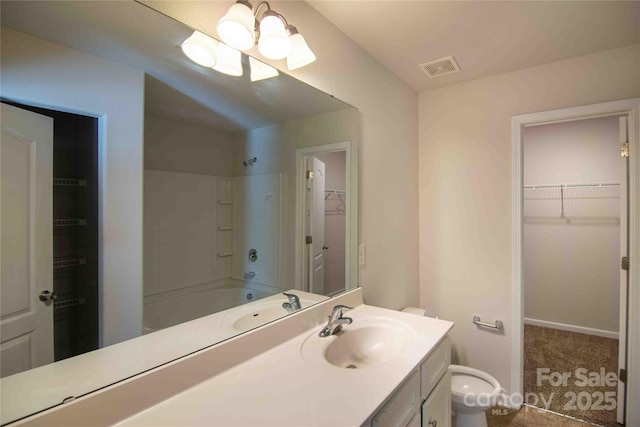 full bath with visible vents, toilet, vanity, bathing tub / shower combination, and a spacious closet