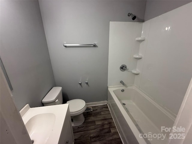 3316 Queens Ln Unit 10, Gastonia, NC 28052 - bathroom featuring baseboards, toilet, wood finished floors, vanity, and  shower combination