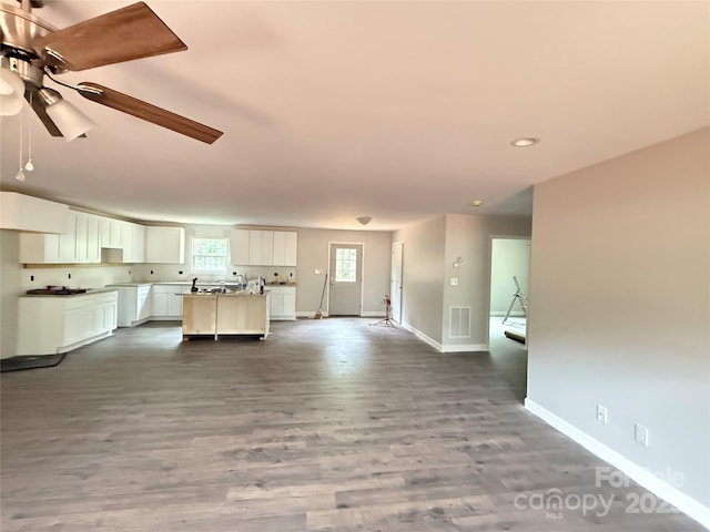 unfurnished living room with baseboards, dark wood-style flooring, recessed lighting, and ceiling fan