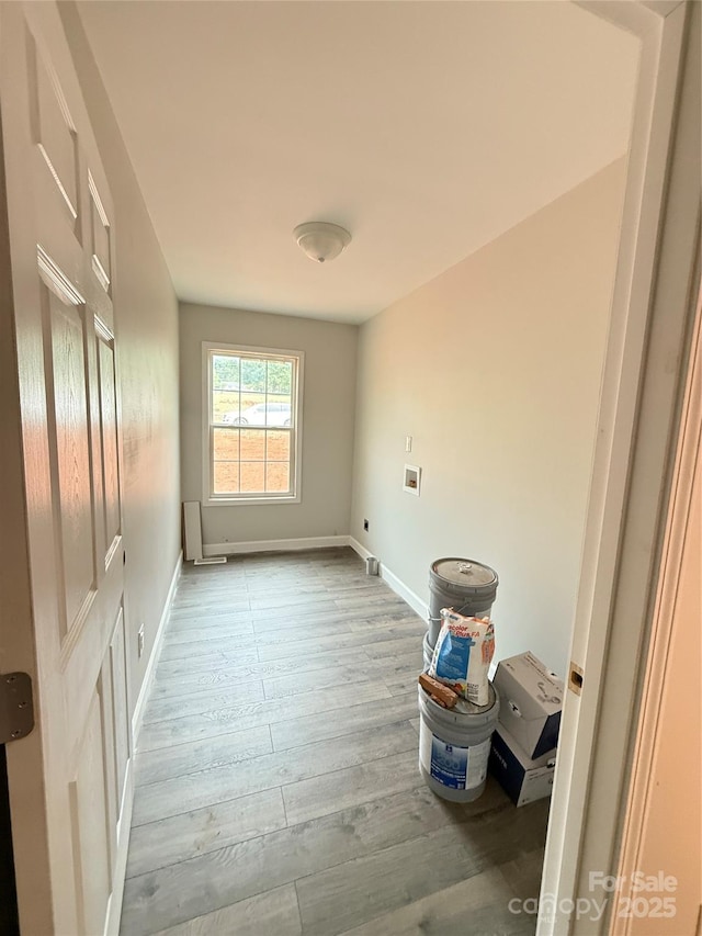 empty room featuring wood finished floors and baseboards
