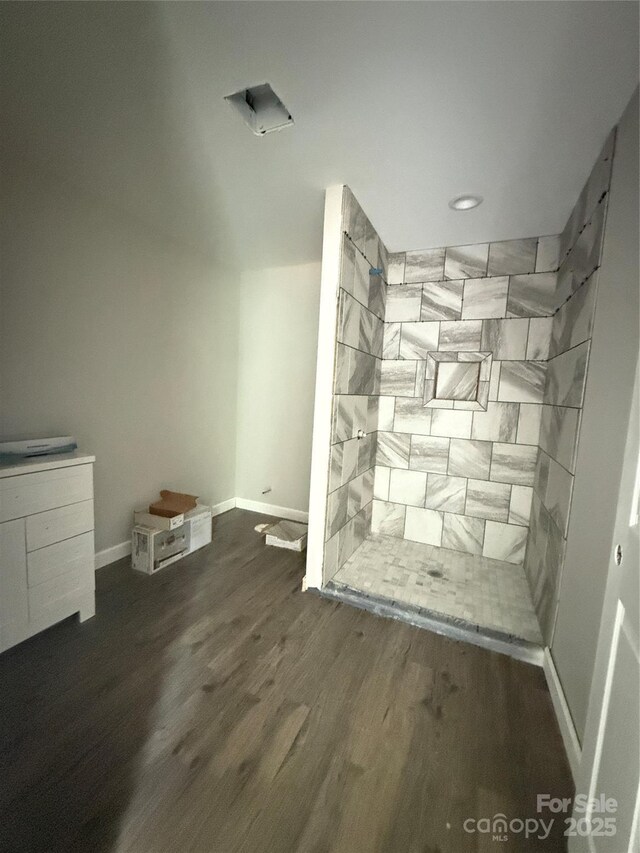 detailed view of wood finished floors, baseboards, and recessed lighting