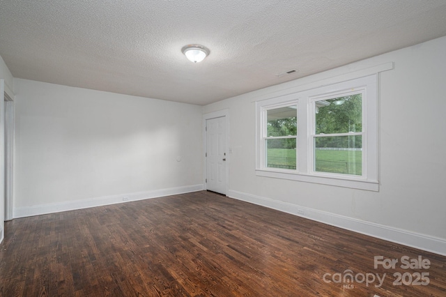 201 Lee Black Rd, Cherryville, NC 28021 - unfurnished room featuring a textured ceiling, visible vents, baseboards, and dark wood-style flooring