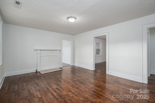 201 Lee Black Rd, Cherryville, NC 28021 - unfurnished living room featuring baseboards, wood finished floors, visible vents, and a textured ceiling
