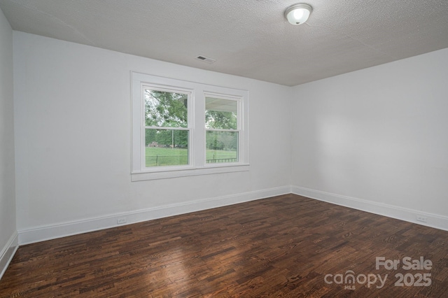 201 Lee Black Rd, Cherryville, NC 28021 - empty room with dark wood-type flooring, visible vents, and baseboards