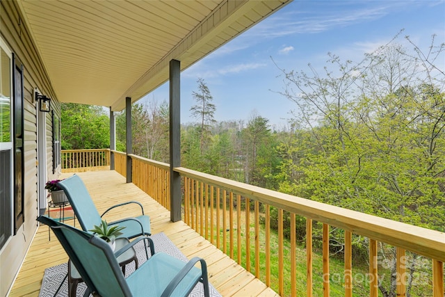 wooden deck featuring a view of trees