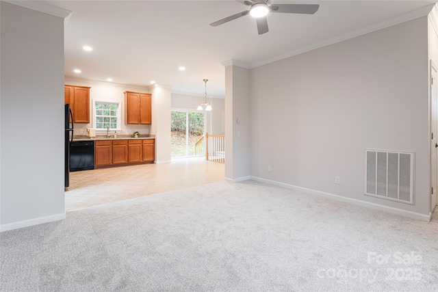 unfurnished living room featuring baseboards, visible vents, light colored carpet, ceiling fan, and crown molding