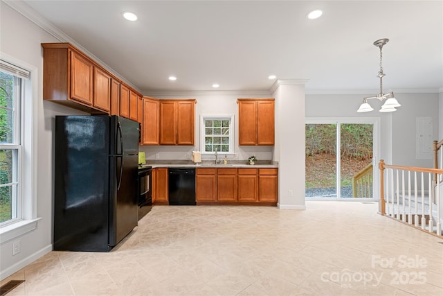 kitchen featuring light countertops, visible vents, a sink, crown molding, and black appliances