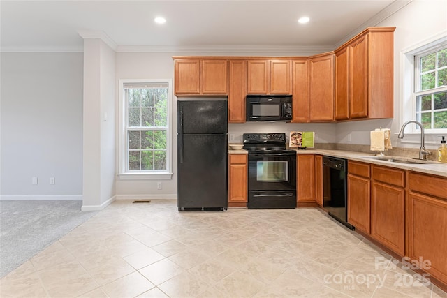 kitchen featuring a sink, black appliances, light carpet, ornamental molding, and recessed lighting