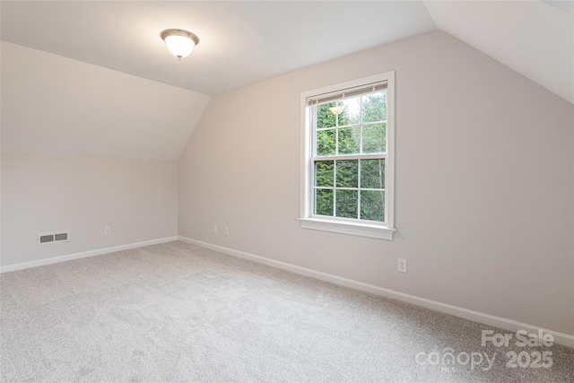 bonus room featuring baseboards, lofted ceiling, visible vents, and carpet