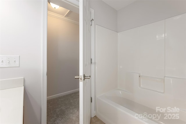 full bathroom with baseboards and shower / tub combination