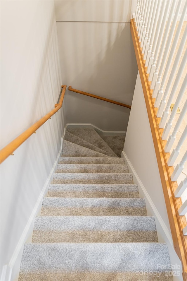 stairs with carpet and baseboards