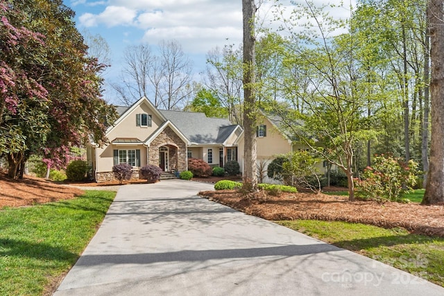 176 Sunset Bay Dr, Troutman, NC 28166 - view of front of home featuring stone siding, driveway, stucco siding, and a front lawn