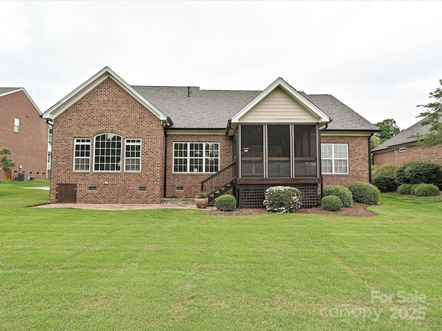 rear view of property featuring brick siding, a sunroom, a lawn, crawl space, and cooling unit