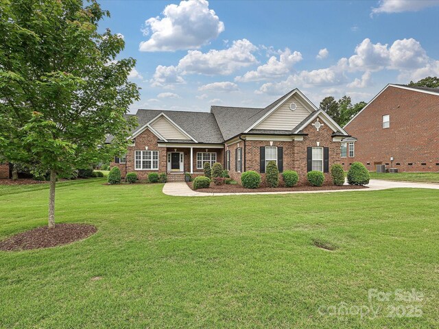 view of front of house with a front yard and brick siding