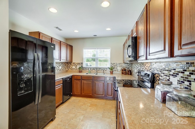 309 River Clay Rd, Fort Mill, SC 29708 - kitchen with light countertops, visible vents, a sink, black appliances, and backsplash