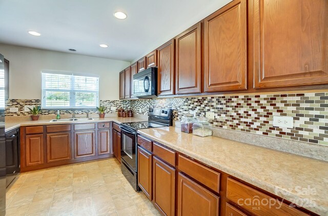 309 River Clay Rd, Fort Mill, SC 29708 - kitchen with recessed lighting, decorative backsplash, a sink, black appliances, and brown cabinets