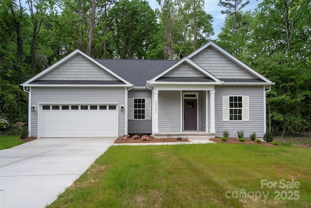 view of front of property with a porch, a garage, roof with shingles, a front lawn, and concrete driveway
