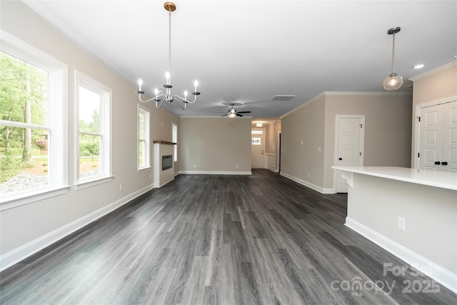unfurnished living room featuring crown molding and plenty of natural light