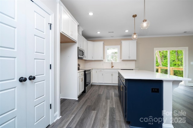kitchen featuring ornamental molding, dark wood-style floors, white cabinets, and appliances with stainless steel finishes