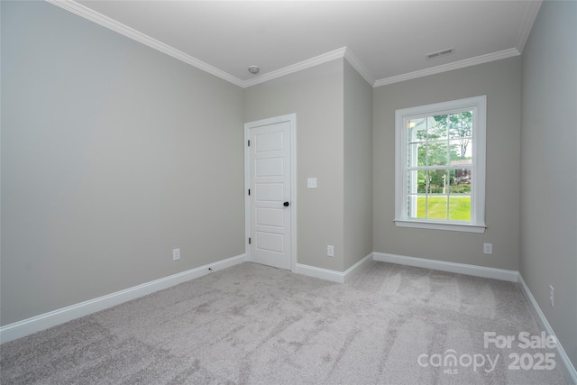 carpeted spare room with crown molding, visible vents, and baseboards