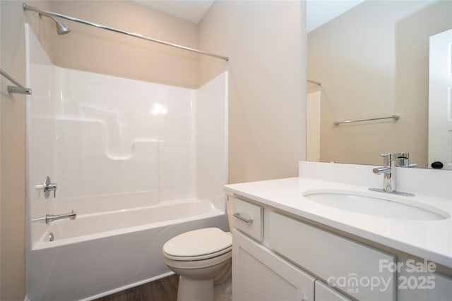 bathroom with wood finished floors, toilet, shower / bath combination, and vanity