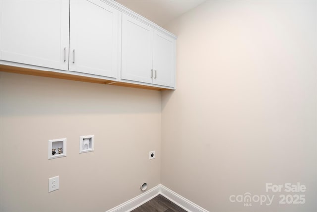 laundry area featuring cabinet space, washer hookup, dark wood-type flooring, electric dryer hookup, and baseboards
