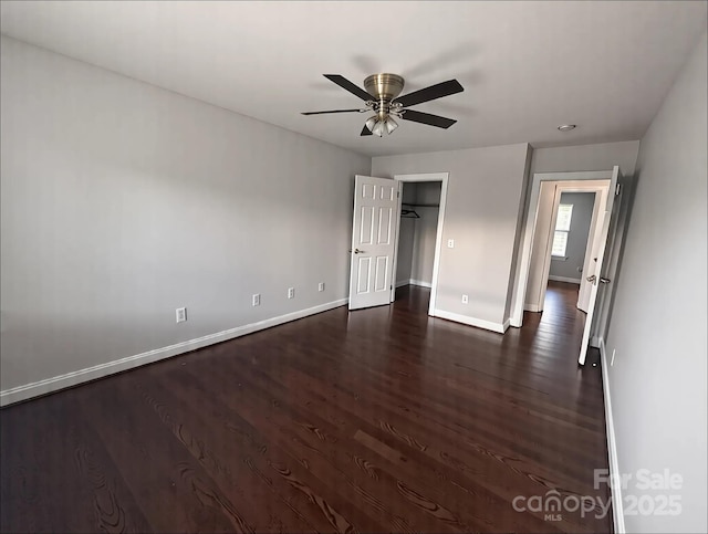 unfurnished bedroom featuring ceiling fan, baseboards, and dark wood-style floors