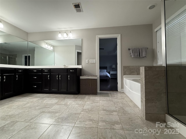 ensuite bathroom featuring double vanity, tile patterned flooring, ensuite bath, visible vents, and a garden tub