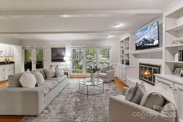 5125 Winding Brook Rd, Charlotte, NC 28226 - living area featuring ornamental molding, built in shelves, a brick fireplace, and light wood finished floors
