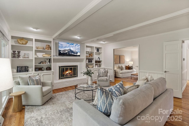 5125 Winding Brook Rd, Charlotte, NC 28226 - living area featuring a fireplace, crown molding, wood finished floors, and built in shelves