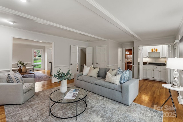 5125 Winding Brook Rd, Charlotte, NC 28226 - living room with wainscoting, ornamental molding, and wood finished floors