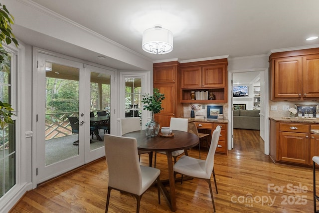 5125 Winding Brook Rd, Charlotte, NC 28226 - dining space featuring light wood-type flooring, ornamental molding, and french doors