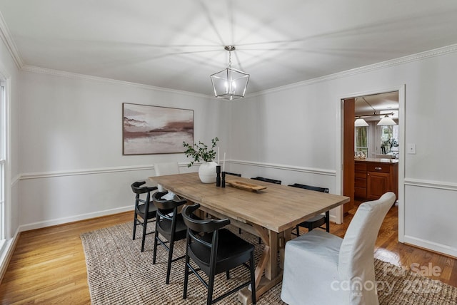 5125 Winding Brook Rd, Charlotte, NC 28226 - dining area featuring an inviting chandelier, crown molding, and light wood finished floors