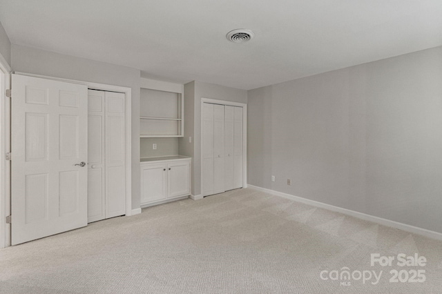 5125 Winding Brook Rd, Charlotte, NC 28226 - unfurnished bedroom with baseboards, multiple closets, visible vents, and light carpet